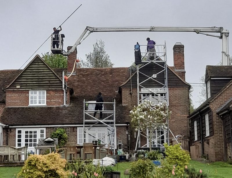 The Roof Moss Cleaners using cherry picker and scaffolding to clean roof safely and professionally in Cranfield, Bedfordshire